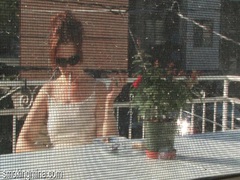 KiloPics.net presents: Cute chick smokes on the porch as he films it