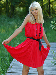 KiloPics.net presents: Naughty teen appears in her sexy red dress and starts removing it passionately and moving slowly.
